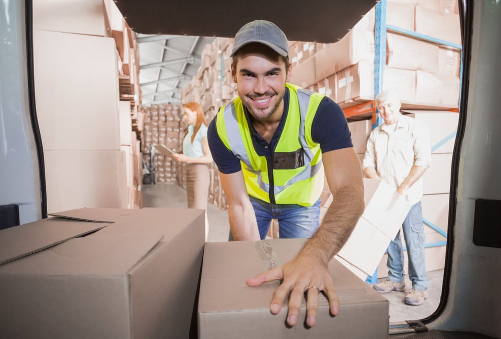 Delivery driver loading his van with boxes outside the warehouse-1