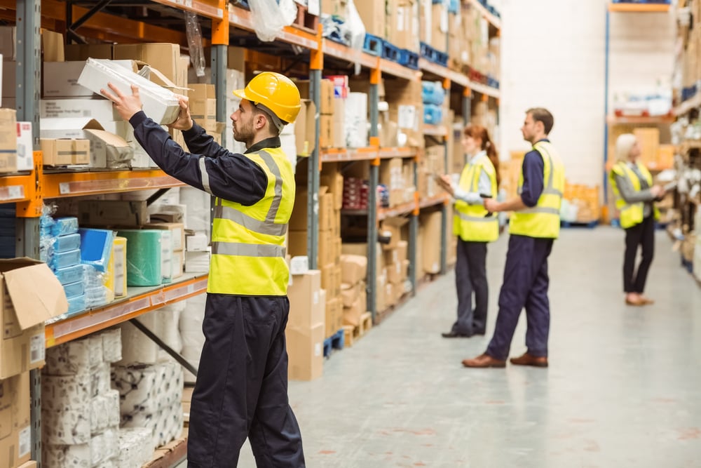 Warehouse worker taking package in the shelf in a large warehouse in a large warehouse-Nov-28-2023-03-45-56-7678-PM